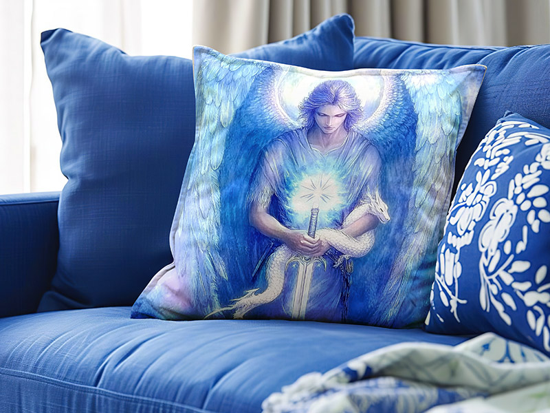 Ein dekoratives Kissen auf einem Sofa zeigt eine eindrucksvolle Darstellung des Erzengels Michael in leuchtenden Blautönen. Die Engelsfigur mit leuchtendem Schwert strahlt Stärke, Klarheit und Schutz aus.